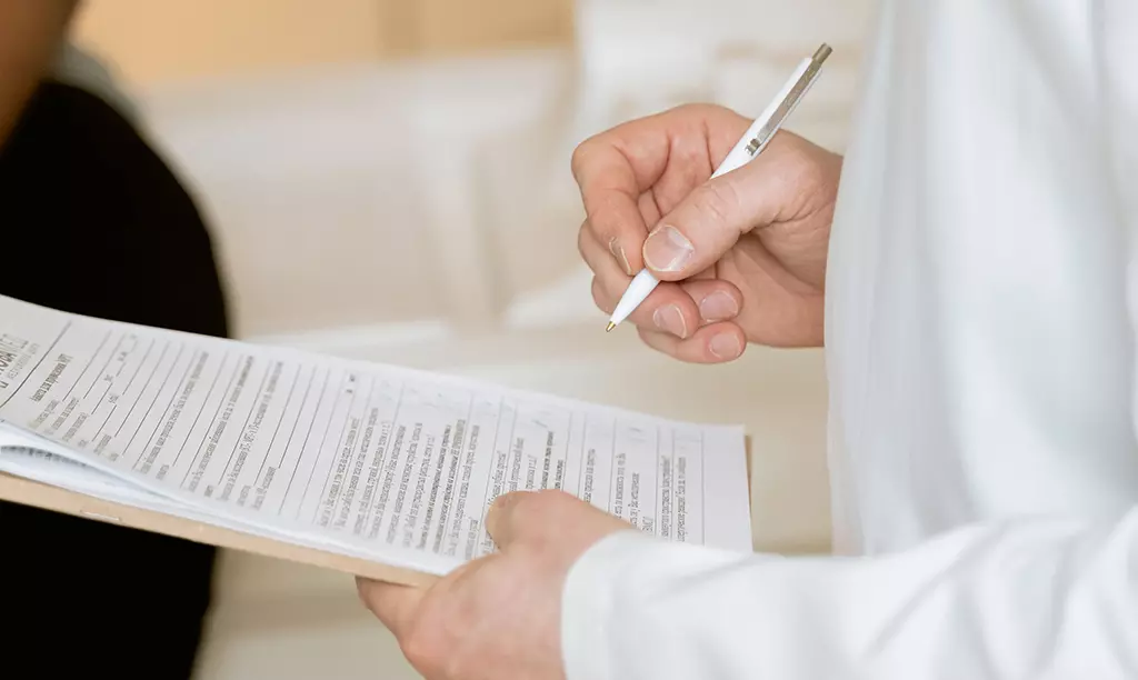 Médico realizando relatório para solicitação do benefício Disability Allowance na Irlanda.