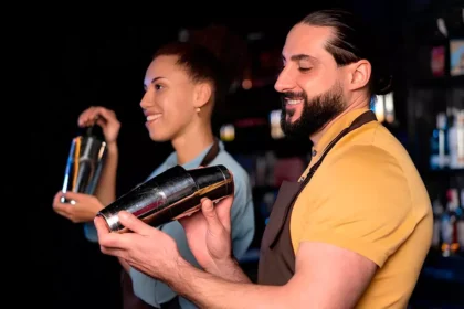 Bartenders trabalhando em um pub na Irlanda preparando bebidas durante o expediente.